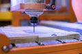 CNC milling machine while carving a wooden table. cutter control