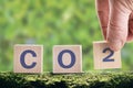 CO2 cubes on a green background, the concept of energy saving and emission reduction. Lower CO2 emissions to limit