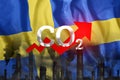 CO2 emissions into the atmosphere. Pipes with black smoke against the background of the Sweden flag. Industrial air pollution
