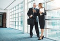 Co-ordinating their schedules using smart technology. a businessman and businesswoman using a mobile phone together in a Royalty Free Stock Photo