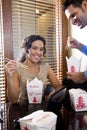 Co-workers in office eating Chinese takeout food Royalty Free Stock Photo