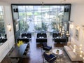 co working corner open space office with black sofa, tables ,large windows with interior