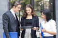 Co working space concept. Asian business looking and thinking in front of folder while stand at co-working space. young women and Royalty Free Stock Photo