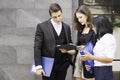 Co working space concept. Asian business looking and thinking in front of folder while stand at co-working space. young women and Royalty Free Stock Photo