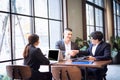 Co-working space concept. Business cooperation and handshake. The young manager is encouraging and appreciating his colleagues