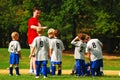 A coach assigns positions at a youth soccer game Royalty Free Stock Photo