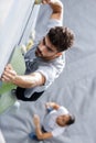 coach climber belay amateur athlete on high climbing wall