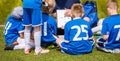 Coach Coaching Kids Soccer Team. Youth Football Team with Coach at the Soccer Stadium