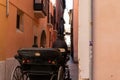 A coach driving in a old thin street in town of Palma de Malorca, Spain