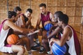 Coach explaining game plan to basketball players Royalty Free Stock Photo