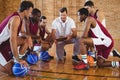 Coach explaining game plan to basketball players Royalty Free Stock Photo