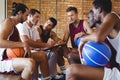 Coach explaining game plan to basketball players Royalty Free Stock Photo