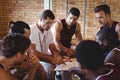 Coach explaining game plan to basketball players Royalty Free Stock Photo