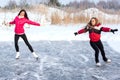 Coach of figure skating with apprentice practise at the frozen lake