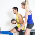 Coach helping with medicine ball training Royalty Free Stock Photo