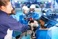 Coach and hockey team putting hands in huddle