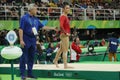 Coach Mihai Brestyan and Olympic champion Aly Raisman of USA during competition on balance beam at women`s all-around gymnastics Royalty Free Stock Photo