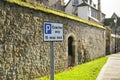 Coach restricted waiting sign seen outside an ancient building in the UK.