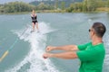 coach showing woman position to water ski