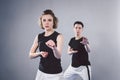 Coach teaches athlete to hit kick. Strong female martial arts athletes in their taekwon-do training. Two young women instructor Royalty Free Stock Photo