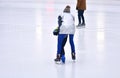 A coach teaches a child to skate