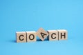 coach text on wooden blocks, business concept, blue background