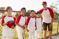 Coach and young boys in a baseball team looking to camera Royalty Free Stock Photo