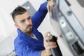 Coachbuilding student working on automobile in garage