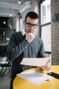 Coacher touching his chin while reading lecture Royalty Free Stock Photo