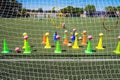 Coaches use plastic cones on the pitch to train younger soccer players Royalty Free Stock Photo