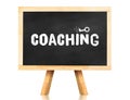 coaching word and key icon on blackboard with easel and reflection on white background,Business concept