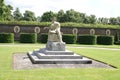 Coade stone statue in a topiary formal garden