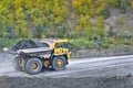 Coal in the back of the yellow truck. Coal mining. Coal delivery.