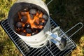 Coal of charcoal grill burning in flames with fire and lighter in barbecue chimney for BBQ evening Royalty Free Stock Photo