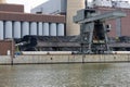 Coal crane with mountains of coal at coal power plant