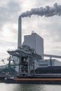 Coal-fired power plant with chimneys, ship and slagheap Royalty Free Stock Photo