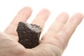 Coal lump carbon nugget in male hand isolated