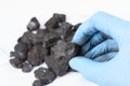Coal lump in scientist hand. Laboratory coal analysis