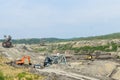 Coal mine accident with a heavy extraction machine inside the coal exploitation. The huge excavator collapsed in the open pit. Royalty Free Stock Photo