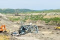 Coal mine accident with a heavy extraction machine inside the coal exploitation. The huge excavator collapsed in the open pit. Royalty Free Stock Photo