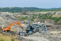 Coal mine accident with a heavy extraction machine inside the coal exploitation. The huge excavator collapsed in the open pit. Royalty Free Stock Photo
