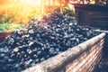 Coal mine wagon. Pile of charcoal in wooden trolley Royalty Free Stock Photo