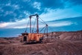 Coal mining at an open pit at sunset