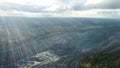 Coal mining at an open pit. Top view of the quarry. Dozers and trucks at buildings site on top aerial view