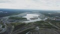 Coal mining at an open pit. Top view of the quarry. Dozers and trucks at buildings site on top aerial view