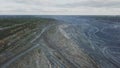 Coal mining at an open pit. Top view of the quarry. Dozers and trucks at buildings site on top aerial view