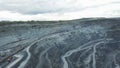 Coal mining at an open pit. Top view of the quarry. Dozers and trucks at buildings site on top aerial view