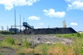Coal mining and storage. Work in the port coal terminal Royalty Free Stock Photo