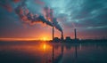 Coal power plant emits smoke into the sky during sunrise