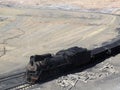 A coal train travelling through the desert